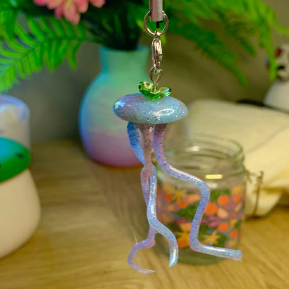 Jellyfish-shaped keychain on a wooden surface with blurred background