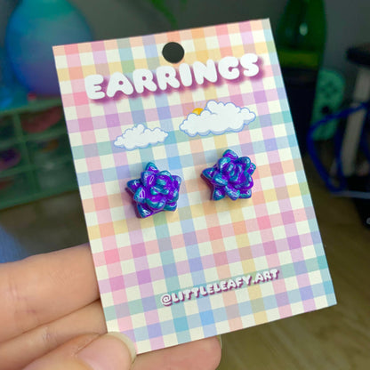Pair of purple star-shaped earrings on a checkered card with 'Earrings' text.