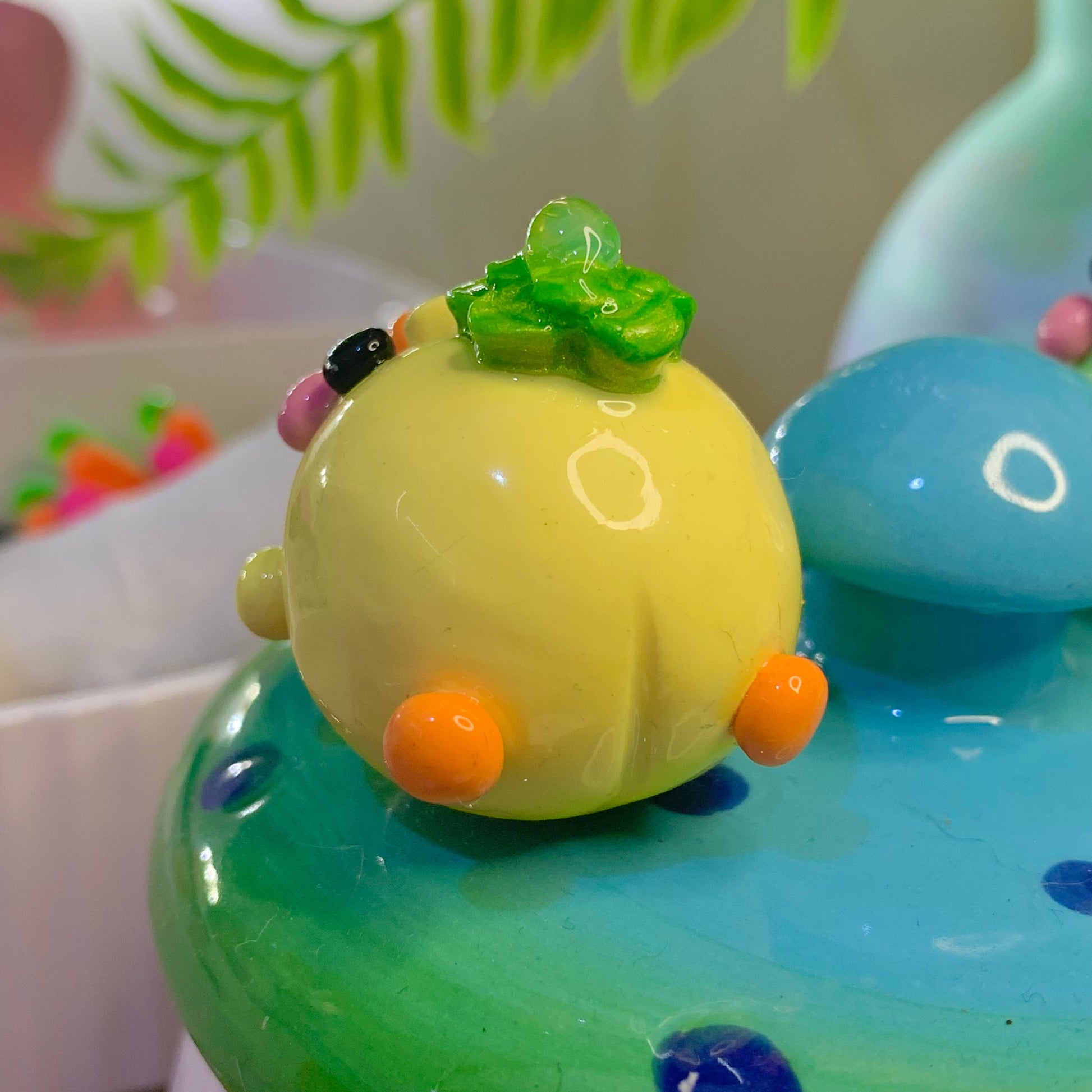 Toy bird on a green surface with a blurred background