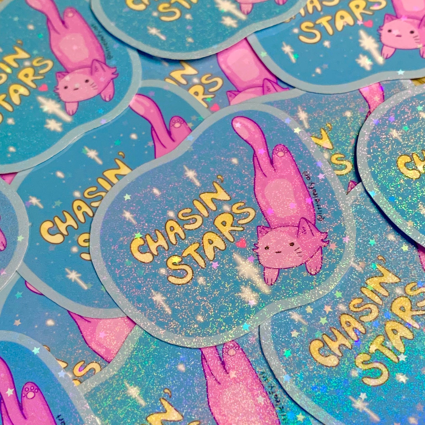 Stickers with 'Chasin' Stars' text and pink cat illustration on a blue background.